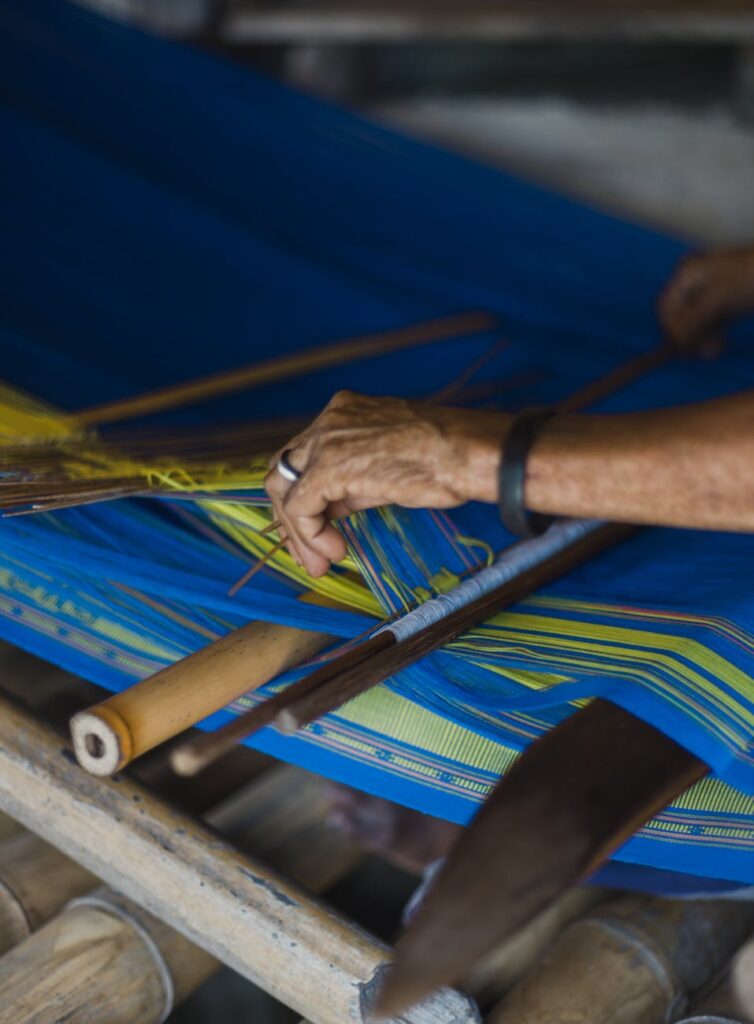 person weaving a mat